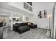 Bright living room with high ceilings, wood floors, open staircase, and view into kitchen at 2005 S Helena St # G, Aurora, CO 80013