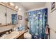 Bathroom featuring fish-themed shower curtain, wood mirror frame and vanity at 17675 E Girard Ave, Aurora, CO 80013