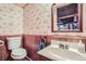 Bathroom featuring wood paneling, bird wallpaper, and wood mirror frame at 17675 E Girard Ave, Aurora, CO 80013