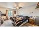 Cozy bedroom featuring a ceiling fan, large bed, and natural light at 17675 E Girard Ave, Aurora, CO 80013