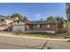 Charming brick home featuring a well-manicured lawn, attached garage, and solar panels at 17675 E Girard Ave, Aurora, CO 80013