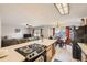 Open-concept kitchen featuring island cooktop and bar, and a dining area perfect for entertaining at 17675 E Girard Ave, Aurora, CO 80013