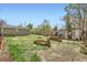 Spacious backyard featuring a garden area, shed, and fire pit perfect for outdoor relaxation and gardening at 7101 E 66Th Ave, Commerce City, CO 80022
