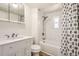 Well-lit bathroom featuring subway tile shower, updated vanity, and stylish black and white decor at 7101 E 66Th Ave, Commerce City, CO 80022