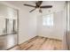 Cozy bedroom with light wood flooring, ceiling fan, and ample natural light at 7101 E 66Th Ave, Commerce City, CO 80022