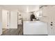 Modern kitchen with white cabinetry, stainless steel appliances, and stylish gray wood flooring at 7101 E 66Th Ave, Commerce City, CO 80022