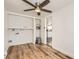 Convenient laundry area with built-in shelving and modern flooring, adjacent to the kitchen at 7101 E 66Th Ave, Commerce City, CO 80022