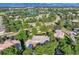 Stunning aerial view of the neighborhood featuring mature trees and a lake in the distance at 6790 W Crestline Ave, Littleton, CO 80123