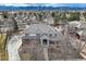 Expansive home with a gray tile roof and mature trees, showcasing the property's setting at 6790 W Crestline Ave, Littleton, CO 80123
