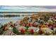 Picturesque aerial view of a neighborhood with a lake and vibrant fall foliage at 6790 W Crestline Ave, Littleton, CO 80123