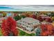 Stunning aerial view of a home surrounded by colorful trees and a lake in the background at 6790 W Crestline Ave, Littleton, CO 80123