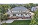 Spacious backyard with a wooden deck, patio, and steps leading to manicured lawn at 6790 W Crestline Ave, Littleton, CO 80123