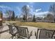 Cozy backyard patio featuring comfortable seating and a spacious lawn with mature trees at 6790 W Crestline Ave, Littleton, CO 80123