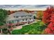 Beautiful backyard with a patio, deck, lush green lawn and fall foliage at 6790 W Crestline Ave, Littleton, CO 80123