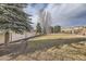Expansive backyard featuring a well-maintained lawn, mature trees, and privacy fencing at 6790 W Crestline Ave, Littleton, CO 80123