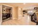Open basement living area with a fireplace, arcade game, and a wine room visible through an open doorway at 6790 W Crestline Ave, Littleton, CO 80123