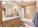 Bright bathroom with a shower-tub combination and a vanity with sink and mirror at 6790 W Crestline Ave, Littleton, CO 80123