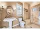 Bright bathroom featuring a walk-in shower, built-in storage, and large vanity mirror at 6790 W Crestline Ave, Littleton, CO 80123