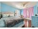 Bright bedroom with light blue walls, hardwood floors, and pink curtains at 6790 W Crestline Ave, Littleton, CO 80123