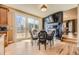 Cozy dining area features a fireplace, TV, and access to a large outdoor deck at 6790 W Crestline Ave, Littleton, CO 80123
