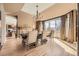 Bright dining room with a modern chandelier, fireplace, and view to the kitchen at 6790 W Crestline Ave, Littleton, CO 80123
