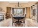Formal dining room with a long table, elegant chandelier, and natural light at 6790 W Crestline Ave, Littleton, CO 80123