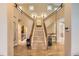 Elegant foyer featuring a grand staircase, hardwood floors, and decorative lighting at 6790 W Crestline Ave, Littleton, CO 80123