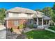 Elegant brick home featuring a manicured lawn, stone pathway, and covered porch at 6790 W Crestline Ave, Littleton, CO 80123