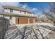 Spacious three-car garage with brick accents and a wide driveway at 6790 W Crestline Ave, Littleton, CO 80123