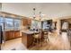 Spacious kitchen with a large center island, stainless appliances, and elegant pendant lighting at 6790 W Crestline Ave, Littleton, CO 80123