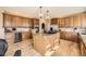 Gourmet kitchen with custom cabinets, granite countertops, and a center island at 6790 W Crestline Ave, Littleton, CO 80123