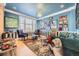 Eclectic living room with bright blue walls and unique art collection, creating a vibrant space at 6790 W Crestline Ave, Littleton, CO 80123