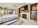 Comfortable bedroom features a fireplace and built-in shelving for plenty of storage at 6790 W Crestline Ave, Littleton, CO 80123