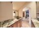 Convenient wet bar area features granite counters and wooden cabinets, perfect for entertaining guests at 6790 W Crestline Ave, Littleton, CO 80123