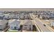 Aerial view of neighborhood with many single-Gathering homes surrounded by street, under a blue sky at 9248 Salida St, Commerce City, CO 80022