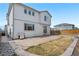 Exterior of home features backyard with stone patio, a stainless steel grill, and rock landscaping at 9248 Salida St, Commerce City, CO 80022