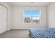 This bedroom features a large window with view, a closet, and carpet at 9248 Salida St, Commerce City, CO 80022