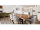 Elegant dining area showcasing hardwood floors, ample seating, and seamlessly integrated with the open kitchen at 9248 Salida St, Commerce City, CO 80022