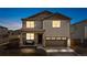 Charming two-story home featuring a covered front porch with stone accents and a two-car garage at 9248 Salida St, Commerce City, CO 80022