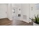 Inviting hallway with hardwood floors leading to a bright living space and a convenient half bathroom at 9248 Salida St, Commerce City, CO 80022