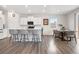 Bright open-concept kitchen featuring a spacious island, hardwood floors, and a cozy dining area at 9248 Salida St, Commerce City, CO 80022
