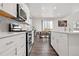 Gourmet kitchen featuring white cabinetry, modern appliances, and a spacious design, perfect for cooking and entertaining at 9248 Salida St, Commerce City, CO 80022