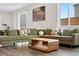 Bright living room showcases a modern sofa, hardwood floors, and sliding glass doors for natural light at 9248 Salida St, Commerce City, CO 80022