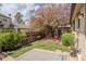 Private backyard featuring a patio, lush lawn, and vibrant flowering tree at 4323 W Ponds Cir, Littleton, CO 80123