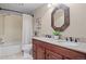 Well-maintained bathroom with a dual sink vanity, decorative mirror, and shower-tub combination at 4323 W Ponds Cir, Littleton, CO 80123