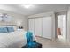 Neutral bedroom featuring an ensuite bathroom and a spacious closet with sliding doors at 4323 W Ponds Cir, Littleton, CO 80123