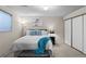 Comfortable bedroom with ample natural light, plush carpeting, and a spacious closet at 4323 W Ponds Cir, Littleton, CO 80123