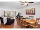Bright dining area with hardwood floors, complemented by a charming wooden table and comfortable seating arrangements at 4323 W Ponds Cir, Littleton, CO 80123