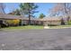 Well-maintained exterior of a brick building with a landscaped lawn and paved driveway on a sunny day at 4323 W Ponds Cir, Littleton, CO 80123