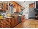 Beautiful kitchen featuring granite counters, warm wood cabinets, and stainless steel appliances with lots of natural light at 4323 W Ponds Cir, Littleton, CO 80123